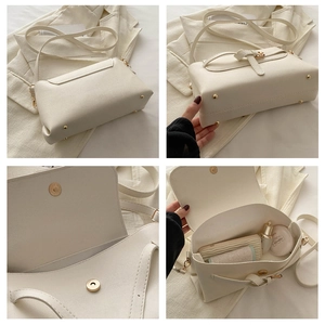 Detail view of white crossbody bag showing golden studs, magnetic closure and interior