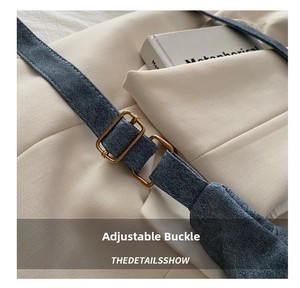 Detail of adjustable blue fabric strap with gold metal buckle on a shoulder bag