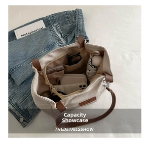 Top view of spacious cream canvas tote interior with pockets holding daily essentials