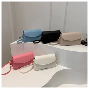 Detailed view of minimalist square flap bags in five pastel colors on a tiered display stand