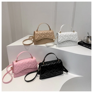 Chic quilted crossbody bags in four colors with gold hardware on display stand