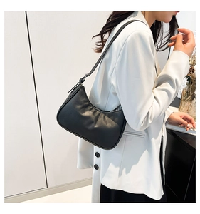 Close-up of the black crescent hobo bag featuring premium faux leather texture and silver zipper