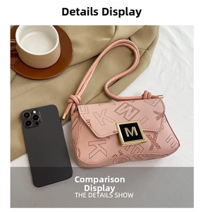 Detail of pink pebbled leather crossbody bag with letter print and golden M metal buckle