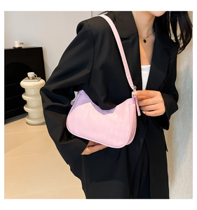 Pink hobo shoulder bag with textured embossing and silver hardware on black blazer