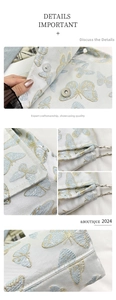 Detail of embroidered butterfly bag featuring magnetic clasp and silver chain strap