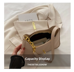 Detailed internal view of beige crescent bag showing large capacity and zipper pocket