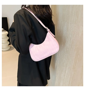 Pink quilted hobo shoulder bag styled on a black oversized blazer for a chic look