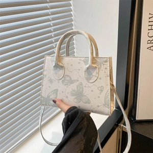 Piccola borsa quadrata bianca con stampa a farfalla verde e doppi manici superiori