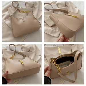 Close-up of beige crescent bag featuring gold chain strap and interior storage layout