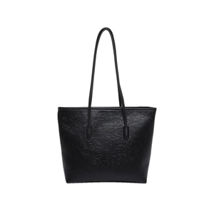 Minimalist black leather tote bag with cartoon embossed heart patterns and top handles