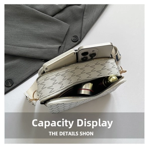 Detail view of white crossbody bag showing dual zippers and large interior capacity