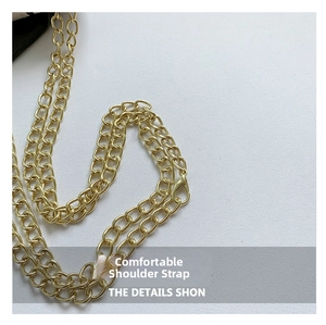 Detail shot of the shiny golden metal chain strap with lobster clasps for small handbags