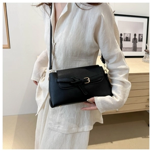 Chic black crossbody flap bag with knot detail and gold hardware for women's fashion