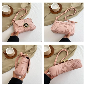 Detail view of pink PU leather shoulder bag with lychee texture and gold letter M buckle