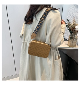 Detail view of women's vintage crossbody bag with brown monogram and wide strap