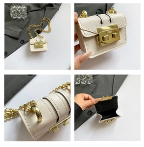 Detail view of mini cream crossbody bag with gold push-lock and chain strap textures