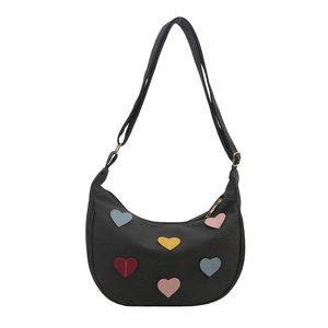 Minimalist black hobo shoulder bag with colorful heart patches and adjustable strap