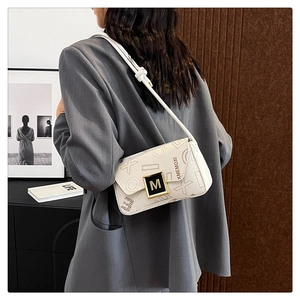 Modern white leather shoulder bag with letter prints and gold buckle on a fashion model