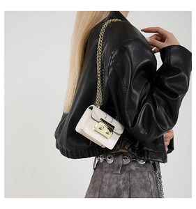 Detailed side view of off-white mini chain bag on model with gold hardware detail