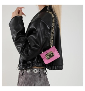 Detailed close-up of a pink mini chain bag with gold metal buckle and leather texture