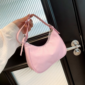 Pink nylon underarm square bag with quilted texture and adjustable shoulder strap