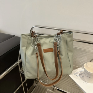 Large sage green tote bag with leather straps and silver chain for daily commuting