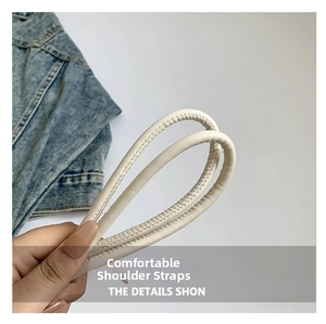 Detail of comfortable cream synthetic leather shoulder strap with fine stitching