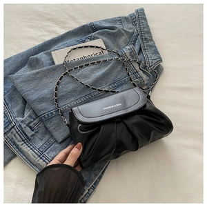 Détail du sac nuage plissé en similicuir noir avec chaîne argentée et texte mode