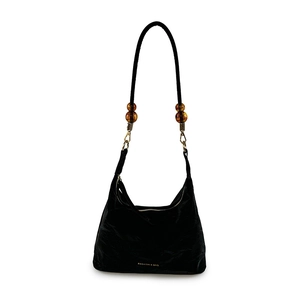 Minimalist black tote bag with amber beads on shoulder strap and gold lettering