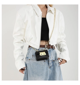 Detailed view of women's white PU leather jacket with black mini chain bag and accessories