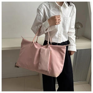 Pink waterproof oxford tote bag with matching pouch shown in a home setting