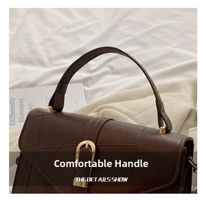 Macro shot of comfortable coffee brown handle and premium litchi texture PU leather
