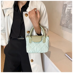 Light green quilted crossbody bucket bag with elegant leather handle for women