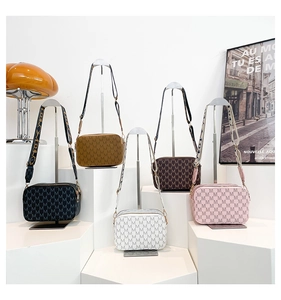 Detailed display of vintage patterned camera bags in five colors with wide straps