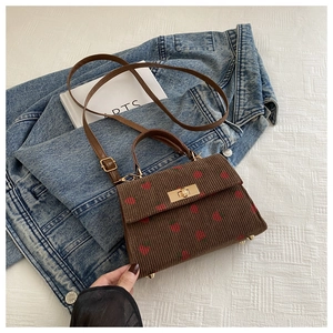 Brown corduroy crossbody bag with red strawberry pattern and golden twist lock closure