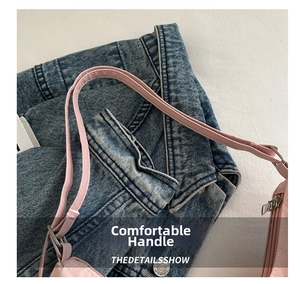 Detailed view of pink PU leather handles with silver metal buckles and refined stitching