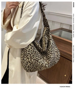 Detail of leopard print canvas tote bag featuring large capacity and a secure zipper closure