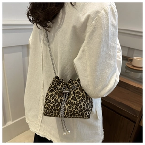 Detail of leopard print bucket bag with silver chain strap and pearl drawstring charms
