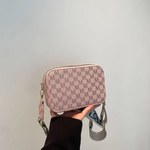 Pink crossbody camera bag with monogram print and wide patterned fabric strap