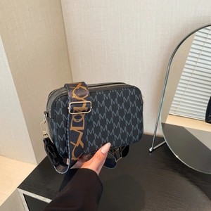 Retro black printed crossbody camera bag with wide colorful guitar strap and gold hardware