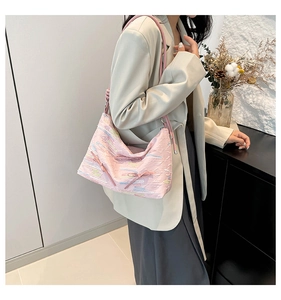 Close-up of pink tote bag featuring textured fabric and cute bow embroidery detail