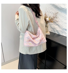 Detailed side view of a pink pleated tote bag with colorful wavy patterns on shoulder