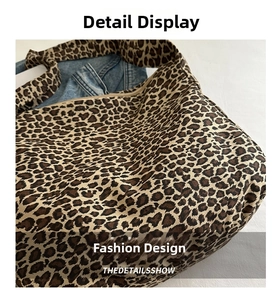 Macro shot of leopard print canvas tote bag featuring texture and zipper closure