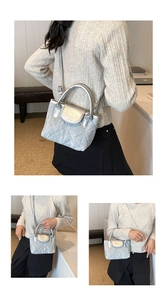 Close-up of silver quilted bucket bag with metallic texture and curved top handle