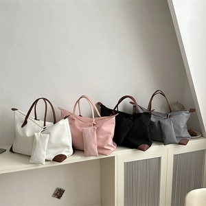 Waterproof nylon tote bag set in four colors with leather handles and inner pouch