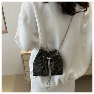 Detail of leopard print bucket bag with silver chain strap and drawstring closure