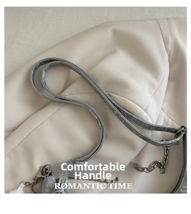 Detail of silver gray faux leather strap with polished metal chain on large tote bag