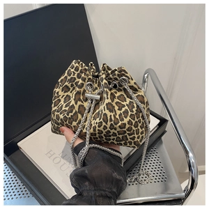 Detailed view of leopard print drawstring bucket bag with silver metal chain strap