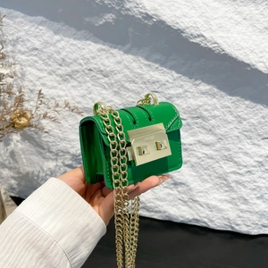 Mini lime green leather chain bag with gold buckle in handheld crossbody style