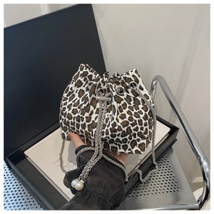 Detail of leopard print bucket bag featuring pearl-tipped silver chain drawstring